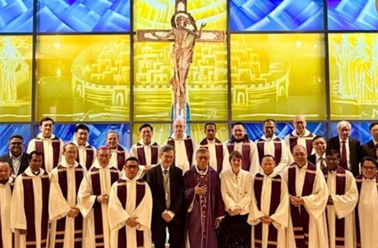 La Iglesia ante la inteligencia artificial: aprender a discernir sin perder el alma Grupo de obispos, sacerdotes y laicos reunidos en una iglesia en Hong Kong, frente a un vitral con Cristo crucificado, tras un encuentro sobre inteligencia artificial y pastoral.
