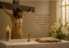 Julio y la Preciosísima Sangre de Cristo: una devoción que nos recuerda hasta dónde llega el amor de Dios Crucifijo sobre un altar con una Biblia abierta, un pequeño cáliz, un cirio encendido y lirios blancos, como representación de la devoción a la Preciosísima Sangre de Cristo durante el mes de julio.